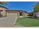 Inviting single-level home featuring a spacious two-car garage and verdant front lawn at 16188 W Hearn Rd, Surprise, AZ 85379