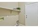 Practical laundry room with a storage shelf, utility connections and an access door at 16188 W Hearn Rd, Surprise, AZ 85379
