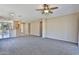Comfortable living room featuring neutral carpet and an open layout leading into the kitchen area at 16188 W Hearn Rd, Surprise, AZ 85379