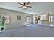 Open-concept living area with neutral carpet, seamlessly connecting to the kitchen with a breakfast bar at 16188 W Hearn Rd, Surprise, AZ 85379