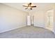 Spacious main bedroom featuring a ceiling fan, neutral paint, and plush carpeting at 16188 W Hearn Rd, Surprise, AZ 85379