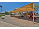 Community playground featuring colorful play structures and a large shade canopy at 16188 W Hearn Rd, Surprise, AZ 85379