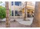 A backyard patio featuring a spiral staircase and outdoor dining area amidst lush landscaping at 16256 S 1St St, Phoenix, AZ 85048