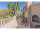 Spacious balcony featuring comfortable rocking chairs and stunning desert views with palm trees on a sunny day at 16256 S 1St St, Phoenix, AZ 85048