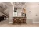 Cozy bar area with stone accents, pendant lighting, seating, and built-in shelving at 16256 S 1St St, Phoenix, AZ 85048