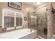 Bathroom features a luxurious soaking tub next to a tiled glass shower enclosure with seat at 16256 S 1St St, Phoenix, AZ 85048
