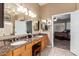 Bathroom featuring double sinks with granite counters, vanity, tiled floor, and walk-in shower at 16256 S 1St St, Phoenix, AZ 85048