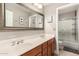 Bathroom with a double sink vanity, large mirror, and a shower with glass doors at 16256 S 1St St, Phoenix, AZ 85048