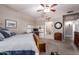 This bedroom features a ceiling fan, a full bathroom, and a full work-from-home setup at 16256 S 1St St, Phoenix, AZ 85048