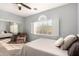 Bright bedroom offering a sitting area, ceiling fan, and a view of the scenery at 16256 S 1St St, Phoenix, AZ 85048