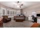 This bedroom features a ceiling fan, a large window with plantation shutters, and a full work-from-home setup at 16256 S 1St St, Phoenix, AZ 85048
