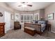 This bedroom features a ceiling fan, a large window with plantation shutters, and a dark wooden bench at 16256 S 1St St, Phoenix, AZ 85048