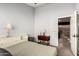 Bright bedroom showcasing a bed, side table with lamp, and access to the hallway at 16256 S 1St St, Phoenix, AZ 85048
