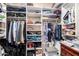 Organized walk-in closet with multiple shelves and clothing racks providing ample storage space at 16256 S 1St St, Phoenix, AZ 85048