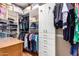 Well-organized walk-in closet featuring multiple shelves and clothing racks for ample storage at 16256 S 1St St, Phoenix, AZ 85048