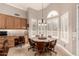 Charming dining area boasts a decorative light fixture, wooden furniture, and bright windows at 16256 S 1St St, Phoenix, AZ 85048