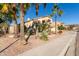 Beautiful stucco home featuring desert landscaping with palm trees and a tile roof at 16256 S 1St St, Phoenix, AZ 85048
