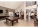 Spacious game room with vaulted ceilings, tile flooring, pool table, and bar seating at 16256 S 1St St, Phoenix, AZ 85048