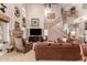 Bright living room boasts a fireplace, large leather sofa, and staircase at 16256 S 1St St, Phoenix, AZ 85048