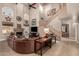 Open living room featuring high ceilings, fireplace, large leather sofa and staircase at 16256 S 1St St, Phoenix, AZ 85048