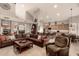 Open concept living room with tile floors, leather seating, and seamless access to the kitchen at 16256 S 1St St, Phoenix, AZ 85048
