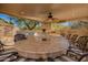 Spacious outdoor kitchen with a built-in grill, granite countertops, and a large stone table for entertaining at 16256 S 1St St, Phoenix, AZ 85048