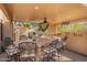 Outdoor kitchen and bar with stone counters and seating offer an ideal space for outdoor entertaining at 16256 S 1St St, Phoenix, AZ 85048