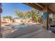 Gorgeous backyard pool featuring a rock waterfall, mature palms, and lush landscaping at 16256 S 1St St, Phoenix, AZ 85048