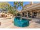 A picturesque pool with a rock waterfall and spa surrounded by lush, tropical landscaping at 16256 S 1St St, Phoenix, AZ 85048