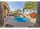 A backyard pool and spa featuring a rock waterfall and mature palms provides a tranquil retreat at 16256 S 1St St, Phoenix, AZ 85048