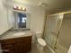 Bathroom featuring a granite topped vanity, tile flooring, and a glass-enclosed shower at 16635 N Cave Creek Rd # 213, Phoenix, AZ 85032