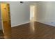 Spacious bedroom with wood-look floors, a walk-in closet and bright, white walls at 16635 N Cave Creek Rd # 213, Phoenix, AZ 85032