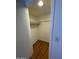 A well-lit walk-in closet with shelving and wood-look flooring at 16635 N Cave Creek Rd # 213, Phoenix, AZ 85032