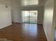 The living room has laminate floors and a sliding glass door for balcony access at 16635 N Cave Creek Rd # 213, Phoenix, AZ 85032