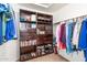 Organized walk-in closet with built-in shelving, drawers, and hanging rods for optimal storage solutions at 17708 W Cactus Flower Dr, Goodyear, AZ 85338