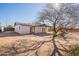 Backyard of house with bare spots and a big tree at 180 S Maple St, Chandler, AZ 85226