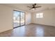 A bedroom with a modern ceiling fan, and large sliding glass doors to the backyard at 180 S Maple St, Chandler, AZ 85226