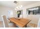 Bright dining room with a modern chandelier, a wooden dining table and six upholstered chairs at 180 S Maple St, Chandler, AZ 85226