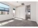 Bedroom featuring carpet floors, natural lighting, and a closet for storage at 18261 W Weatherby Dr, Surprise, AZ 85374