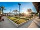 Scenic bocce ball court with shaded seating areas and lush landscaping at 18261 W Weatherby Dr, Surprise, AZ 85374