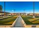 Well-maintained bocce ball court with covered seating and clear blue skies at 18261 W Weatherby Dr, Surprise, AZ 85374