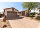 Long brick driveway leading to a two-car garage and a detached single car garage at 18261 W Weatherby Dr, Surprise, AZ 85374
