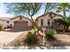 Charming single-story home featuring well-maintained landscaping and a two-car garage at 18261 W Weatherby Dr, Surprise, AZ 85374