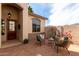 Inviting front patio with seating, a fountain, and a decorative front door at 18261 W Weatherby Dr, Surprise, AZ 85374