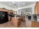 Traditional kitchen with granite countertops, tile flooring and island with seating for seamless cooking and entertaining at 18261 W Weatherby Dr, Surprise, AZ 85374