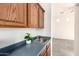 Functional laundry room with upper cabinets, utility sink, and easy access for household chores at 18261 W Weatherby Dr, Surprise, AZ 85374