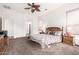Cozy main bedroom featuring carpet floors, and a decorative ceiling fan at 18261 W Weatherby Dr, Surprise, AZ 85374