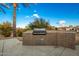 An outdoor kitchen features a built-in grill perfect for entertaining guests at 18261 W Weatherby Dr, Surprise, AZ 85374