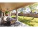 A covered patio offers shade for outdoor dining, overlooking a well-maintained lawn at 18261 W Weatherby Dr, Surprise, AZ 85374
