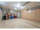 Clean garage interior featuring epoxy floors, storage cabinets, and overhead lighting at 18807 N 1St Ave, Phoenix, AZ 85027